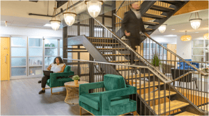 Person sitting in the common area working in a green char